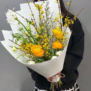 Весенний букет с желтыми ранункулюсами и цветущими ветками форзиции в Можайске